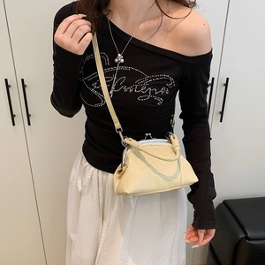 Detail of vintage cream textured leather kiss-lock bag with silver metal frame clasp