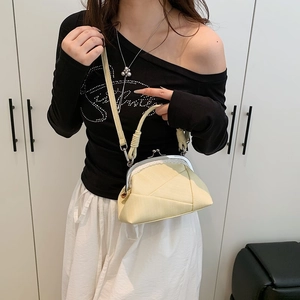 Detail of vintage pale yellow kiss lock handbag with unique geometric pleated texture