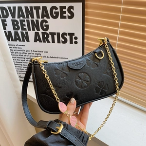 Chic black hobo bag with embossed clover patterns and strawberry chain charms