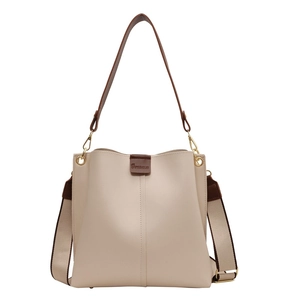 Cream leather bucket tote bag with wide canvas strap and dark brown leather top handles