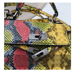 Detailed macro view of the dark nickel swivel lock on snakeskin texture leather bag