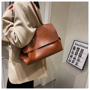 Caramel brown crocodile embossed shoulder bag styled with a beige blazer for office wear