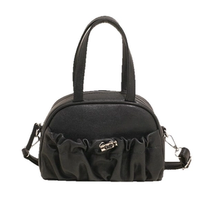 Fashionable black pleated handbag with top handles and adjustable shoulder strap