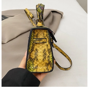 Side view of snake pattern handbag showing gunmetal hardware and textured leather