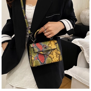 Close-up of colorful snakeskin textured mini bag with metallic turn-lock and handle