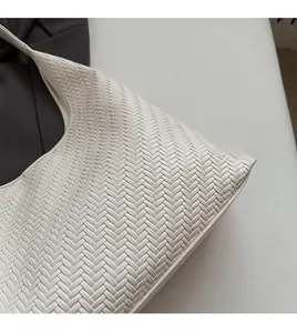 Close-up of white woven texture on a modern tote bag showing soft material details