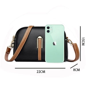 Black pebbled leather shell bag with brown straps and dimensions 22x15x8cm