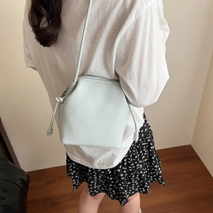 Minimalist mint green litchi texture crossbody bag with stylish knot details on strap