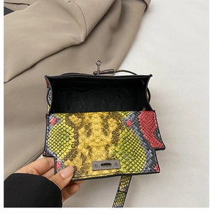 Detail view of colorful snake skin texture handbag with vintage metal twist lock