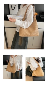 Close-up of khaki woven hobo tote bag showing detailed herringbone texture and wide strap