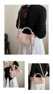 Three-way view of a pink pleated crossbody bag worn by a model in a minimal setting