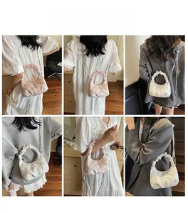 Detailed views of crossbody bags with butterfly embroidery and ruched handles