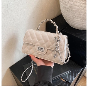 Elegant beige quilted chain crossbody bag with silver hardware and woven handle