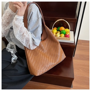 Detailed view of the woven brown hobo bag showing intricate texture and large capacity