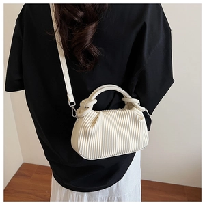 Detail of cream pleated crossbody bag with fine vertical texture and silver metal hooks