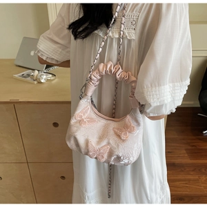 Detail of light pink floral embroidery handbag with 3D butterfly appliques and lace