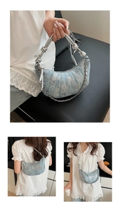 Détail du sac croissant en denim bleu clair avec paillettes argentées et chaîne métal