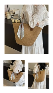 Close-up of woven straw tote bag featuring brown leather trim and a blue floral silk scarf