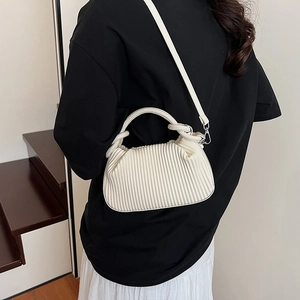 Elegant white pleated hobo bag with a minimalist half-moon design and crossbody strap