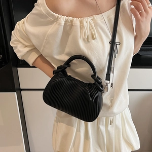 Chic black pleated crossbody bag with a round handle and cloud-like matte texture