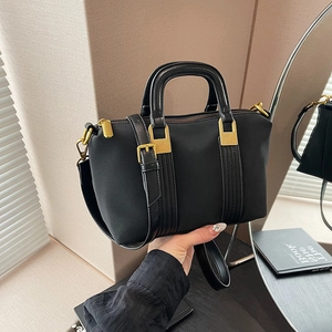 Elegant black Boston handbag with gold hardware and adjustable strap for women