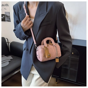 Pink Boston handbag featuring high-quality lychee texture leather and a metal chain pendant