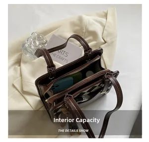 Detail view of large capacity dark brown tote with checkered pattern and dual compartments