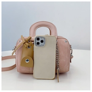 Pink Boston handbag with top handle and side chain detail shown next to a smartphone for scale