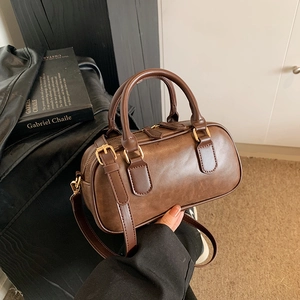 Vintage brown Boston handbag in matte PU leather with gold hardware and dual handles