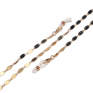 Golden metal eyewear chain with oval pendant pieces and non-slip silicone loops