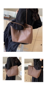 Détail du sac cabas marron en cuir grainé avec logo doré et fines anses pour le transport