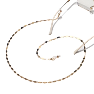 Gold anti-slip eyewear chain featuring polished oval metal plates and silicone loops
