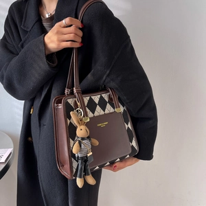 Chic quilted tote bag with brown leather accents and a woven bunny charm for women