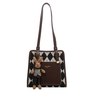 Fashionable rhombus canvas tote bag with brown leather trim and a cute bunny pendant