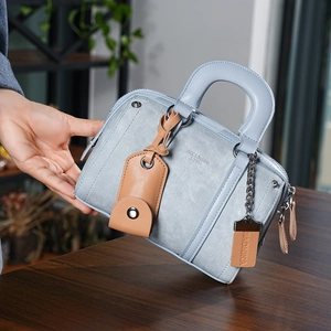 Light blue faux leather Boston handbag with textured finish and dual top handles