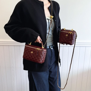 Quilted wine red bucket bags with gold floral hardware and adjustable chain straps