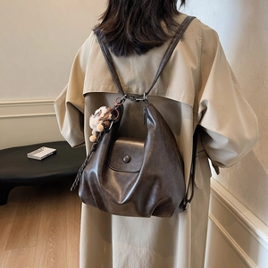 Deep brown leather vintage backpack for women with soft texture and flap closure design