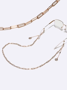 Close-up of rose gold paperclip glasses chain featuring V logo charms and silicone loops