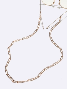 Close-up of golden rectangular link eyewear chain with adjustable silicone connectors
