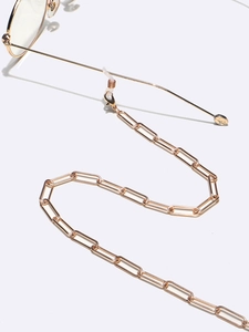 Detail of gold oval link eyewear chain with lobster clasp and silicone loop