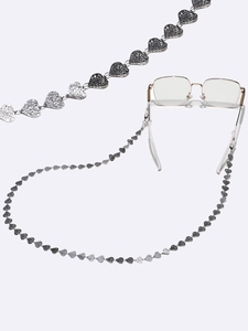 Detail of silver heart-shaped chain links on a stainless steel anti-slip eyewear strap