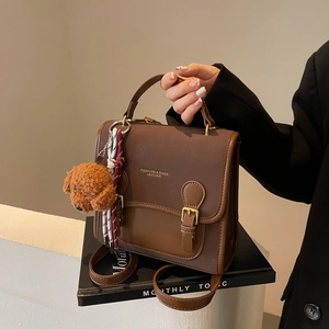 Brown retro leather handbag and crossbody bag with a cute plush dog pendant charm