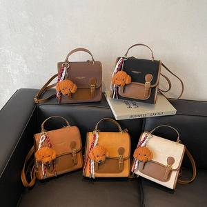 Chic multi-color leather backpacks with teddy charms on a sofa for casual travel