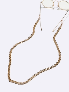 Golden round metal link eyeglass chain with adjustable silicone loops shown with glasses
