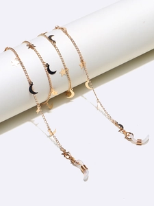Detailed view of gold star and crescent moon eyewear chain with anti-slip silicone ends