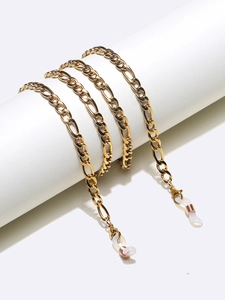 Detailed view of golden Figaro chain eyewear strap with adjustable white silicone loops
