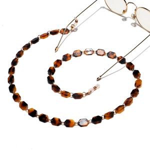 Fashion acrylic tortoiseshell glasses chain with gold metal rings on white background