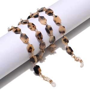 Close-up of hexagonal leopard print acrylic glasses chain with gold metal connectors