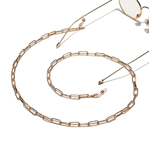Golden oval link metal eyewear chain with adjustable white rubber ends on white background