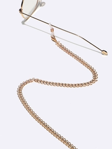 Elegant gold leaf-shaped eyeglass chain with adjustable rubber loops on white background